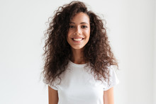 Portrait Of A Smiling Pretty Girl With Long Curly Hair
