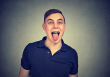 Closeup Portrait Of A Man Sticking His Tongue Out At You