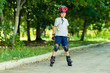 © alexeytsurkan - Little boy riding on rollers in the summer in the Park. Happy child in helmet learning to skate.