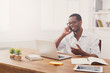 © Prostock-studio - Young black businessman call mobile phone in modern white office
