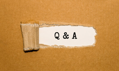 Wall Mural - The text Q and A appearing behind torn brown paper