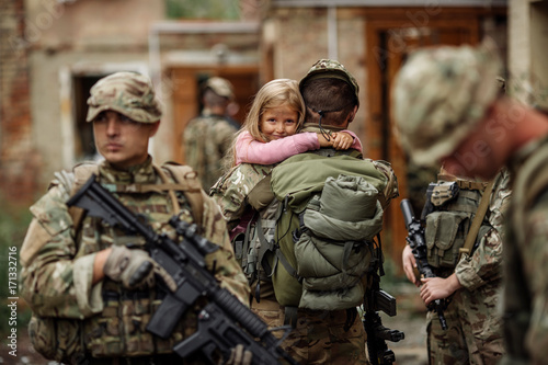 Fotografía Rangers and children on battlefield background