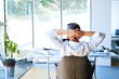 © Halfpoint - Businessman at the desk in his office resting.