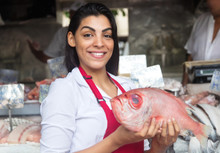 Beautiful Woman Selling Fresh Fish On A Latin Fish Market