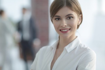 Poster - portrait of young business woman on the background of the office