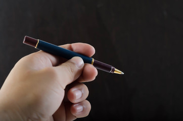 Woman hand holding pen isolated on background