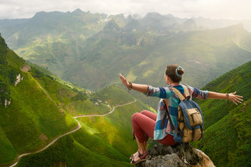 Hiker with backpack in mountains enjoying view at mountains.