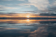 © Jordan Herschel - Symmetry view of Bonneville Salt Flats against cloudy sky at sunset