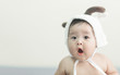 © chompoo - Soft focus Cute Asian male baby sitting on a towel. Blurred background.