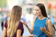 © Antonioguillem - Two friends talking seriously on the street
