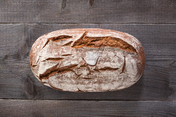 Baked bread on wooden background