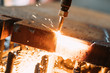 © NDABCREATIVITY - Oxygen torch cuts steel sheet. CNC gas cutting machine. Bright sparks