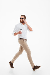 Wall Mural - Handsome young bearded man drinking coffee