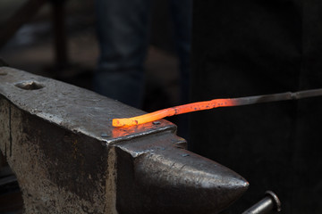 Making the horseshoe from heated red rod