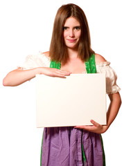 Canvas Print - Attraktive junge Frau im Dirndl mit Schild 