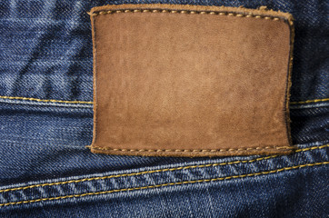 blank leather jeans label sewed on a blue jeans