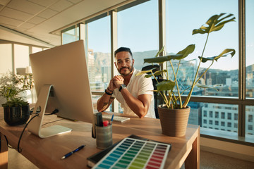 Wall Mural - Handsome male entrepreneur sitting at his desk