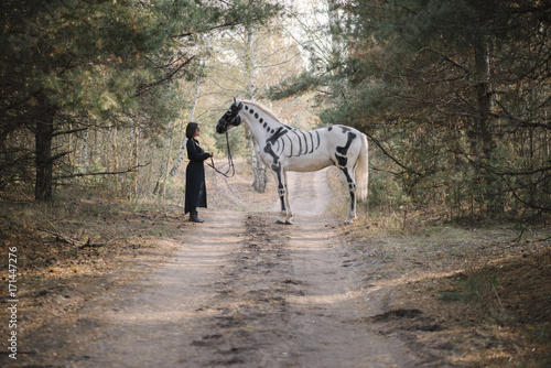 Beautiful Woman In Black Standing Behind Her White Horse Painted As Skeleton In The Autumn Forest Wall Mural Anastasianess Beautiful Woman In Black Standing Behind Her White Horse Painted As Skeleton In The Autumn Forest Wall Mural Anastasianess