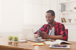 © Prostock-studio - Young black businessman with mobile phone in modern white office