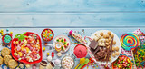Assorted colourful party sweets with copy space