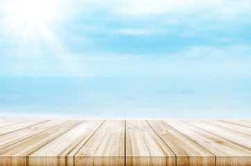 Wall Mural - Empty wooden table top with blurred sea and sky background. Abstract background.