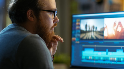 Poster - Male Video Editor Works with Footage and Sound on His Personal Computer. He Works in a Cool Office Loft.