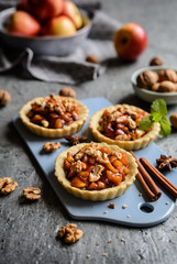 Wall Mural - Fruit tartlets filled with caramelized apple pieces, cinnamon and walnuts