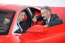 Seller And Rich Customer Discussing The Ferrari Performances