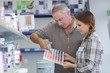 © auremar - female hardware store worker helps buyer customer