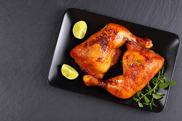 Poster - roasted chicken legs on black plate