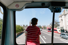 Boy Sightseeing In London On A Bus