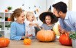 © JenkoAtaman - happy family mother father and children cut pumpkin for   halloween