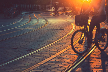 Blurred of people riding bicycle during the sunset in the city of Bordeaux in vintage style and grain texture with copy space