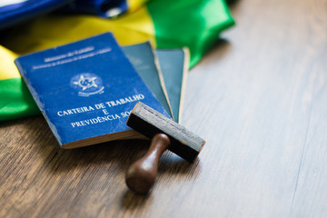 Brazilian work document and social security with stamp on the table and Brazilian flag