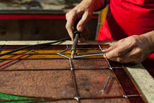 Artisan Making Stained Glass Panels In His Workshop