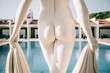 © Vera Lair/Stocksy - Close-up of sunlit statue nude ass