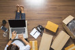 © kromkrathog - Top view of women working laptop computer from home on wooden floor with postal parcel, Selling online ideas concept