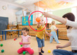 © Andrey Kuzmin - Happy children playing with ball and ring in kindergarten