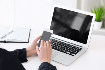 Sticker - Young woman using mobile phone for searching information in internet at table