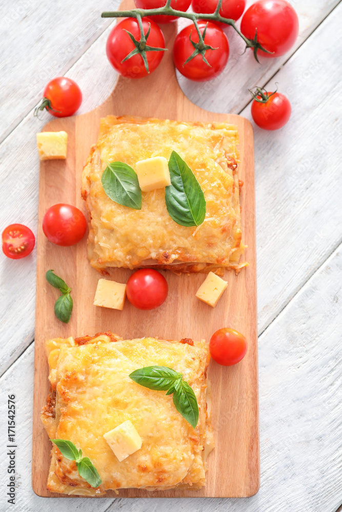 Tasty lasagna on wooden board