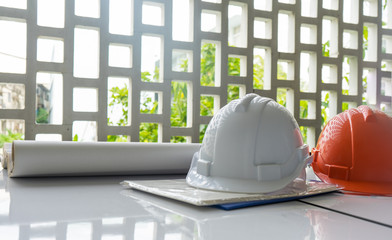 Architect desk ,Business,engineering concept, architecture concept. two helmet on the table, soft focus