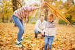 © chika_milan - Caucasian girl laying down on leafs at the autumn