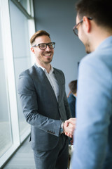 business people shaking hands in modern office