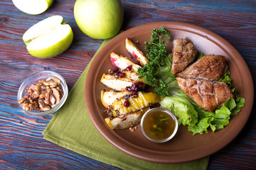 Wall Mural - Roasted duck chops with apples walnuts and cranberry, top view