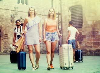 Tourists taking walk in town together