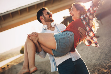 Truly happy playful couple having fun at beach