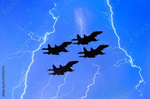 Group of combat fighters jet against the background of lightning thunderstorms w Poster Mural XXL