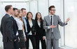 © ASDF - businessman and a group of young business people