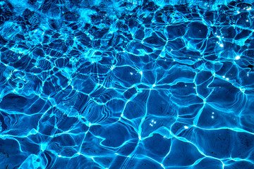 water in swimming pool with sun reflection. blue water. water abstract background
