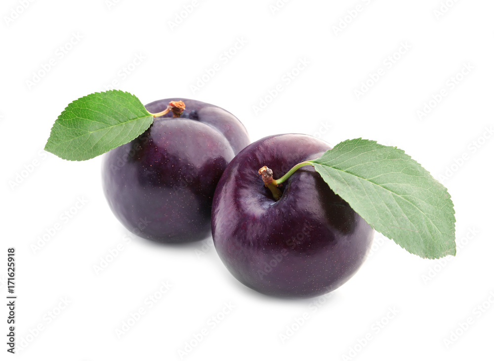 Fresh ripe plums on white background